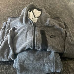 Boys Nike Tech size large..small tear in pants leg